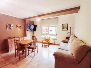 un salon avec un canapé et une table dans l'établissement Apartamento Rosalía de Castro Ribadeo, à Ribadeo