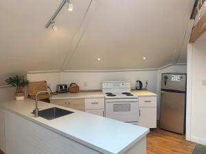 a kitchen with a white stove and a sink at Cozy and rustic cabin in Nelson