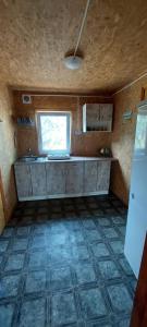 a small kitchen with a counter and a window at ДАЧА на Студенческой in Karolino-Buhaz +29 photos