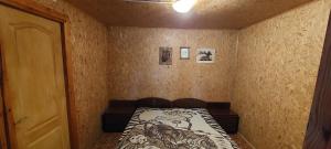 a small room with a bed with a drawing on it at ДАЧА на Студенческой in Karolino-Buhaz