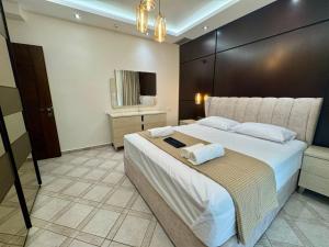 a bedroom with a large bed with two towels on it at House Vistonida in Xanthi