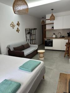 a living room with a couch and a kitchen at VMJ side sea view in Perea