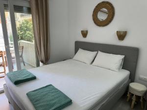 a bedroom with a bed with two towels on it at VMJ side sea view in Perea +10 photos