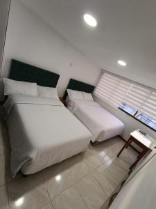 Postel nebo postele na pokoji v ubytování Hotel Hierbabuena y Restaurante