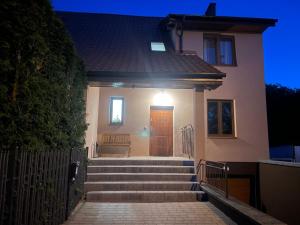 a house with stairs leading up to a door at Szczytno Mazury Krzyżacki Loft Apartamenty u Krzyżaka in Szczytno