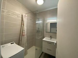 a bathroom with a shower and a toilet and a sink at Sea Breeze Gujan-Mestras in La Celle-sous-Gouzon