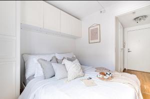 a bedroom with a white bed with a book on it at Charming Duplex near the beautiful Akerselva river in Oslo