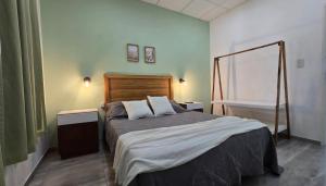 a bedroom with a large bed and a bath tub at Casa de Campo El Molino in Federación
