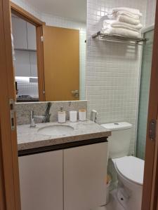 a bathroom with a sink and a toilet at Studio Smart lindo e funcional in Salvador