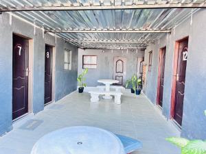 a hallway with a table and a bench in a building at Executive Galaxy Guest House Nkowankowa Extension 2 in Tzaneen