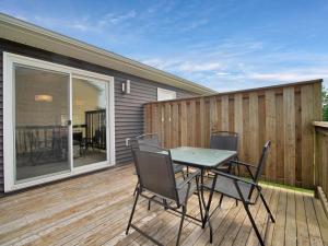 a patio with a table and chairs on a deck at Comfortable 3BR Getaway in Riverview