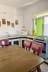 een keuken met een tafel en stoelen en een fornuis bij Beit Ahlam Quiet Duplex Villa with Terrace and Scenic View near Umm Qais Ruins in Um Qeis