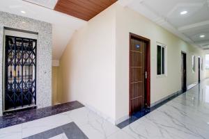 a hallway with two doors in a building at Hotel O Ramavarapadu Near PVR Icon in Vijayawada +34 photos