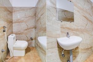 a bathroom with a toilet and a sink at Hotel O Ramavarapadu Near PVR Icon in Vijayawada