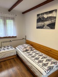 Кровать или кровати в номере Pokoje gościnne Kozica