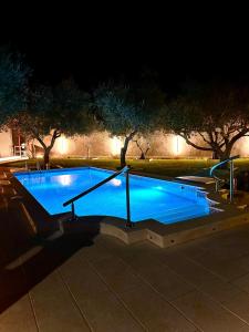 a large swimming pool at night with lights at Villa Forever More in Kaštela