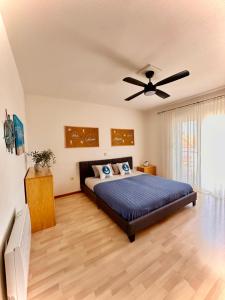 a bedroom with a bed and a ceiling fan at Villa Forever More in Kaštela