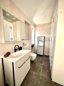 a bathroom with a sink and a toilet at Villa Forever More in Kaštela +8 photos