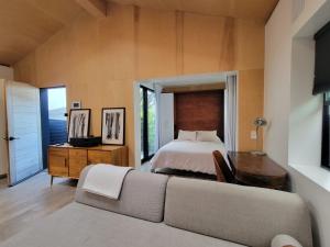 a living room with a couch and a bed at Private Venice Beach Luxury Bungalow, Outdoor Tub, Steps To Ocean & Abbot Kinney in Los Angeles