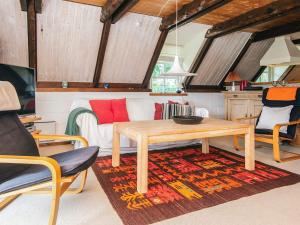 a living room with a table and a couch at 5 person holiday home in Ringkøbing-By Traum in Nørby