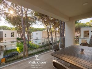 a dining room with a table and a large window at Melia Grove Apartment 325 in Draçi