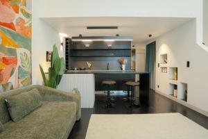 a living room with a couch and a kitchen at Exclusive apartment in Lisbon in Bicas