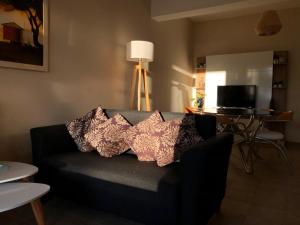 a living room with a couch with pillows on it at Lōla Beach House - Playa Unión in Playa Unión +6 photos