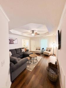 a living room with a couch and a table at Crescent Gardens-3 Miles from UA in Tuscaloosa