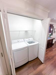 a white laundry room with a washer and dryer at Crescent Gardens-3 Miles from UA in Tuscaloosa +18 photos