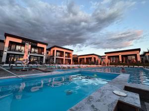 a large swimming pool in front of a building at Modern House in Solotvyno
