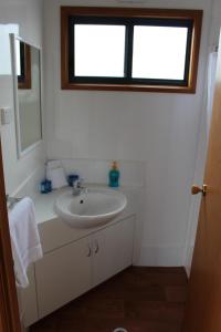 a bathroom with a sink and a window at Golden Terrace Holiday Park in Lakes Entrance