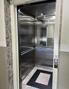 a glass door to a walk in shower in a room at SPAZIO GOMES E COSTA vip in Cabedelo