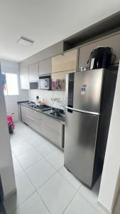 a kitchen with a stainless steel refrigerator at SPAZIO GOMES E COSTA vip in Cabedelo