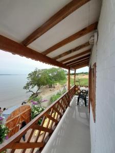 a balcony of a house with a view of the ocean at Cabaña Barbacoas1 in Santa Ana