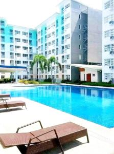 a swimming pool in front of a building at Cozy place at seawind condo, Davao City Near davao airport SMX Sm lanang Sasa wharf in Davao City