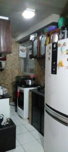 a kitchen with a white refrigerator and a stove at cris Gomes cop30 in Ananindeua