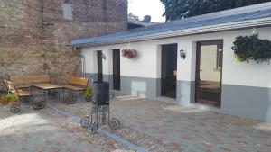 a patio with a table and a bench and a building at Ventspils Centra Apartamenti in Ventspils