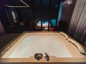 a bath tub with a faucet in a room at Motel Paris - Fushë Kosovë in Vragolija
