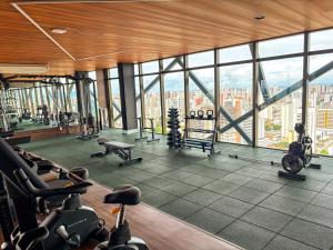 a gym with a view of the sydney skyline at Studio 600m da praia in Fortaleza