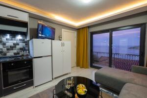 a kitchen and living room with a view of the ocean at Boutique Apartment with Sea View in Turunç Crush House in Turunc