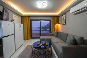 a living room with a couch and a table at Boutique Apartment with Sea View in Turunç Crush House in Turunc