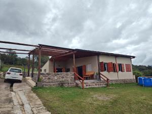 a house with a car parked in front of it at La Paskana in La Caldera