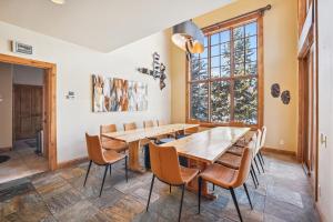 a dining room with a wooden table and chairs at Trot Ski-House in Breckenridge +64 photos
