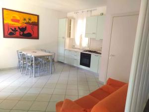 a kitchen and dining room with a table and chairs at Holiday Homes in Rosolina Mare 24977 in Rosolina Mare