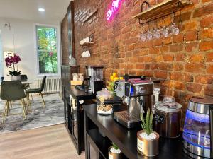 a kitchen with a brick wall and a counter top at BP STAYS - Hotel-Style, No Host, Professionally Managed ID280 in Jersey City