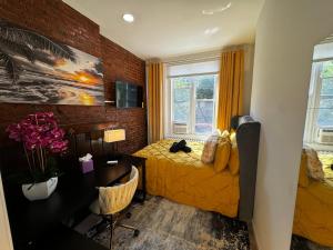a bedroom with a bed and a desk and a window at Hotel-Style, No Host, Professionally Managed ID280 in Jersey City