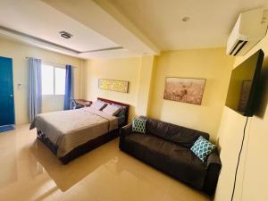 a bedroom with a bed and a couch at Unlock the Perfect Space for You in Pooc