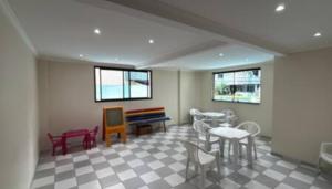 a room with chairs and a table and a bench at Apartamento com varanda in Samaritá +12 photos