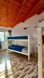a bedroom with a bunk bed and a wooden ceiling at Complejo bosque del peñon in Casa Grande