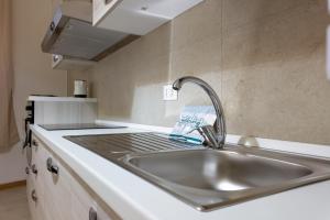 a kitchen counter with a sink in a kitchen at Vacanze Cisternone Livorno centro in Livorno +72 photos